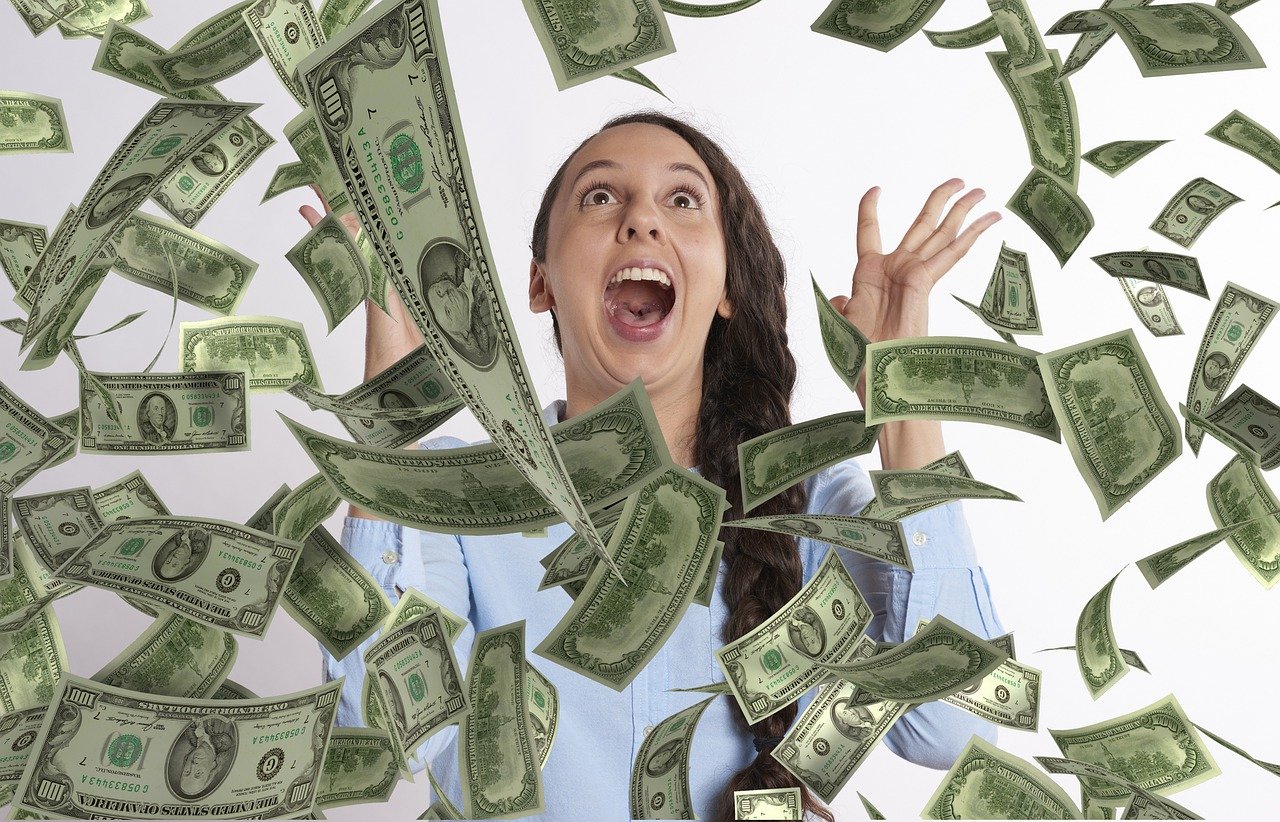 woman celebrating with money thrown in air